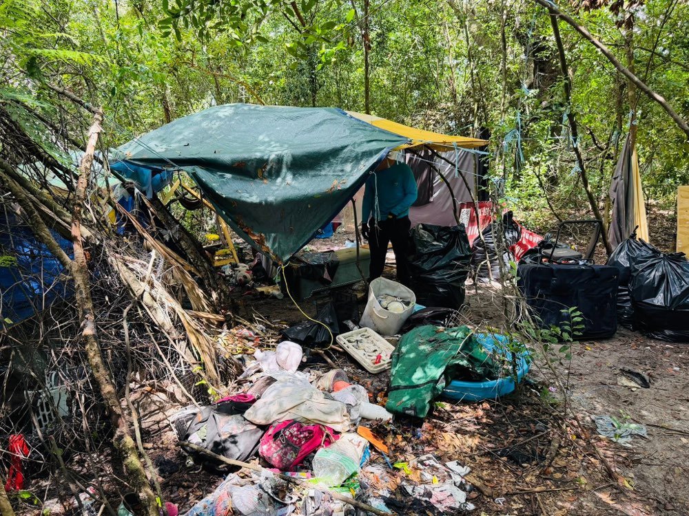 Grandson's Services crew clearing an abandoned encampment in the woods